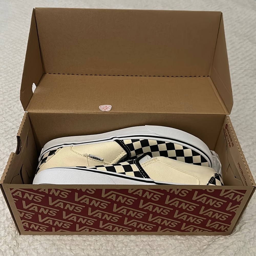 BRAND NEW! Slip on vans, checkered, women’s size nine and a half.
